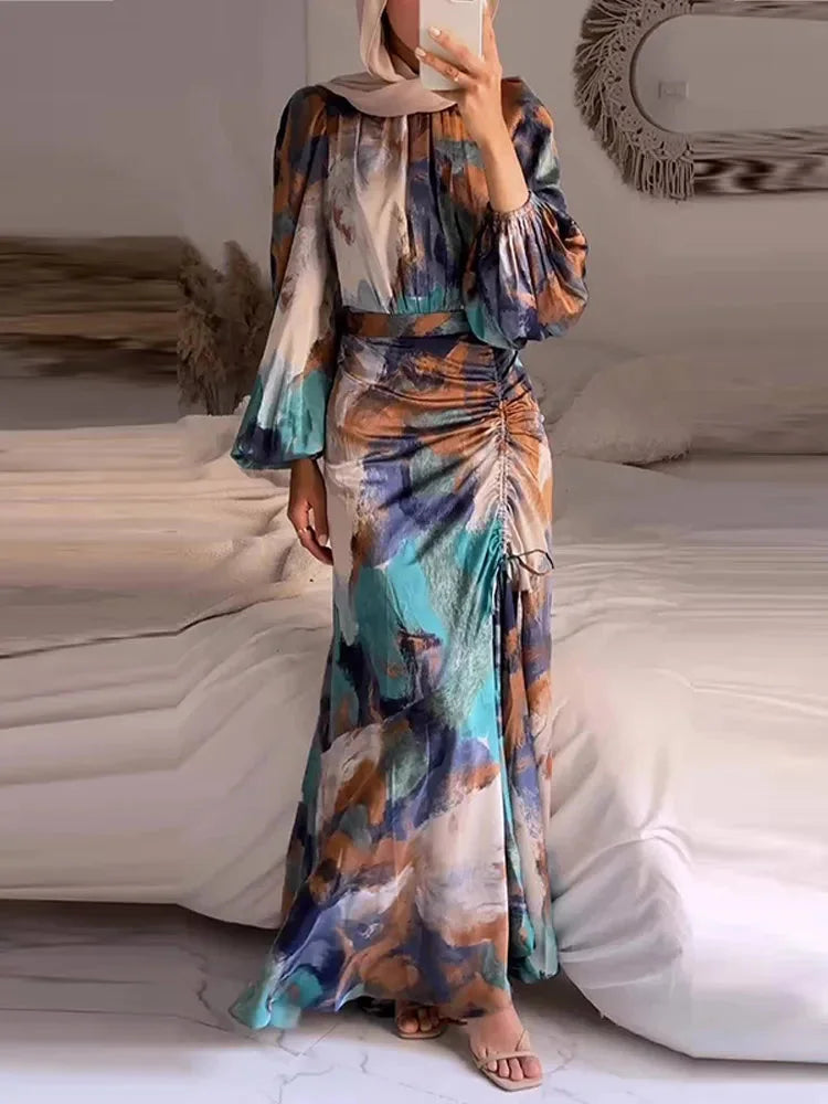 Multicolored pleated maxi dress with sleeves made of lightweight breathable fabric, featuring a vibrant and eye-catching…