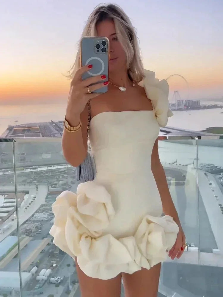 "White strapless ruffled mini dress with a charming design in soft material."