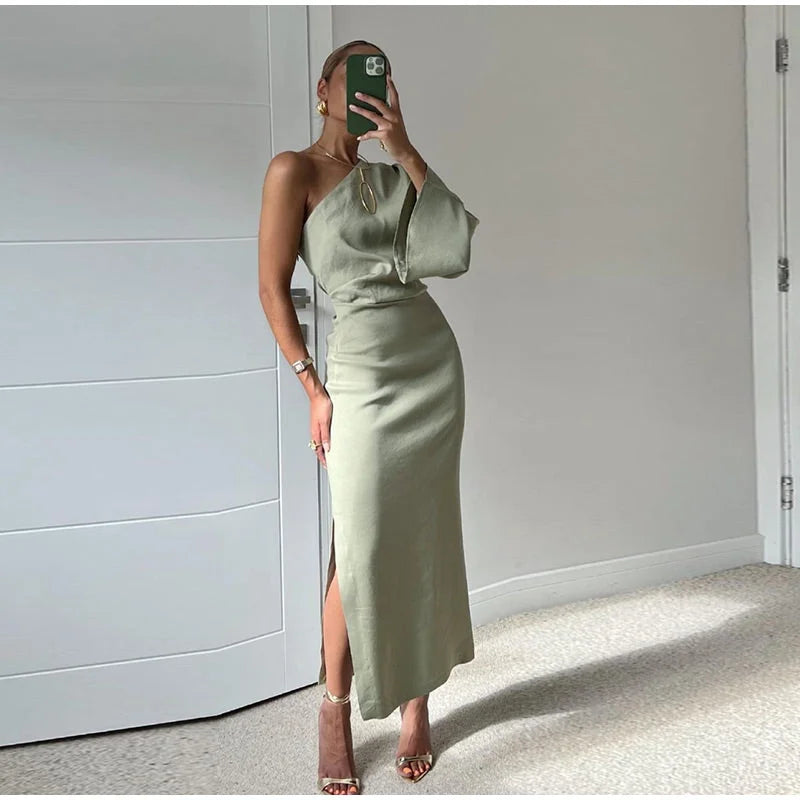 Olive one-shoulder maxi dress in Green Gray, featuring a sleek slit design. Made from soft, flowing fabric for all-day…