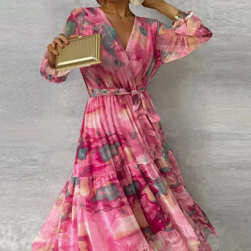 "Women's pink printed maxi dress with long sleeves, featuring a elegant design. Perfect for day-to-night wear."
