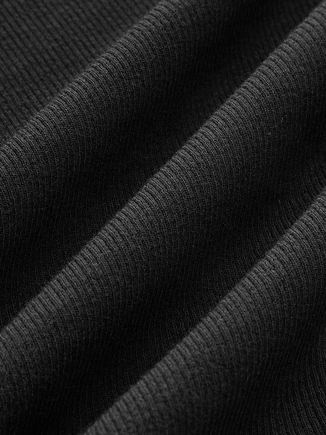 Sleeveless top in ribbed knit with asymmetrical design in black.