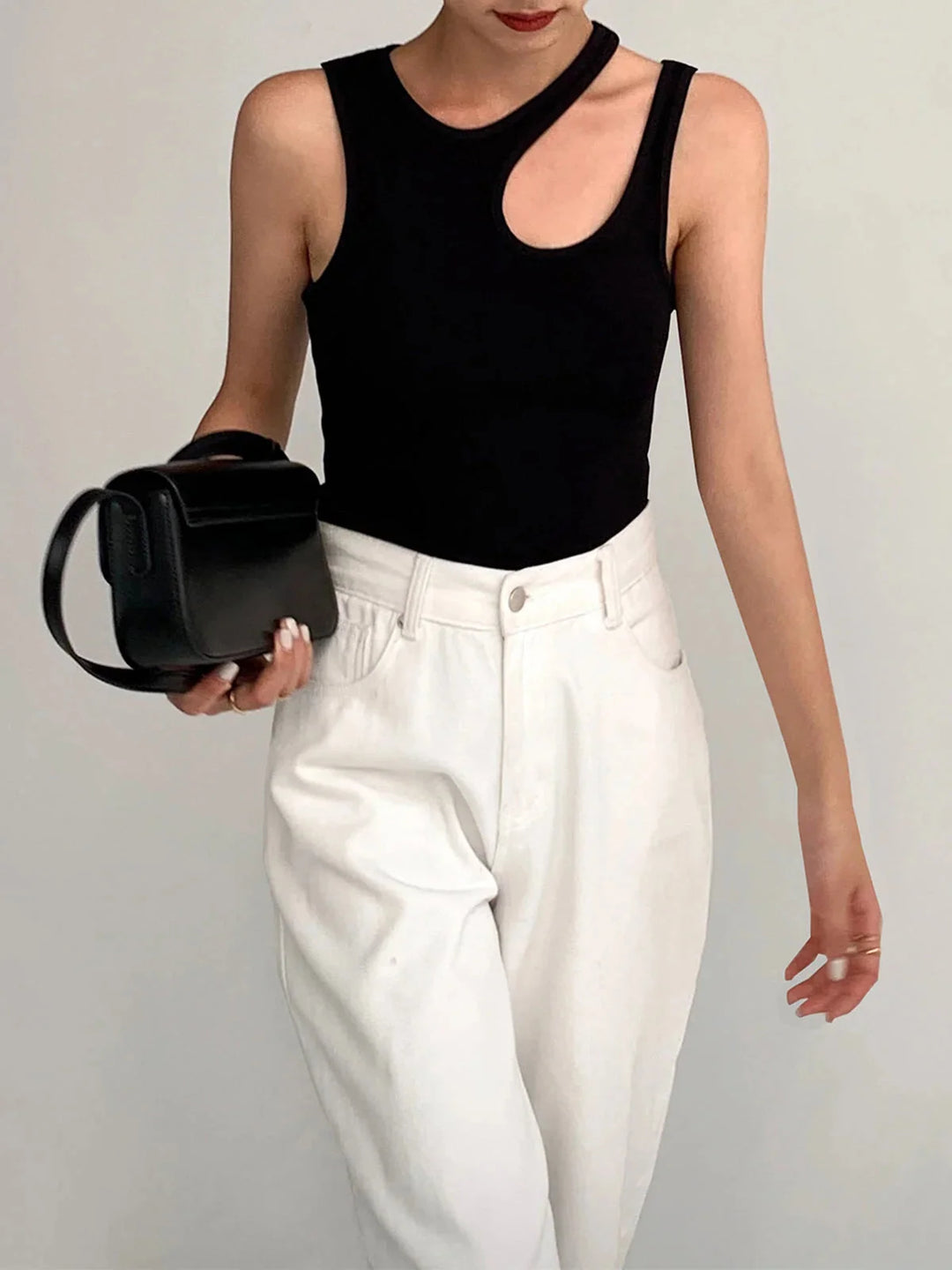 Sleeveless top in ribbed knit fabric with asymmetric design, perfect for adding a modern twist to your outfit.