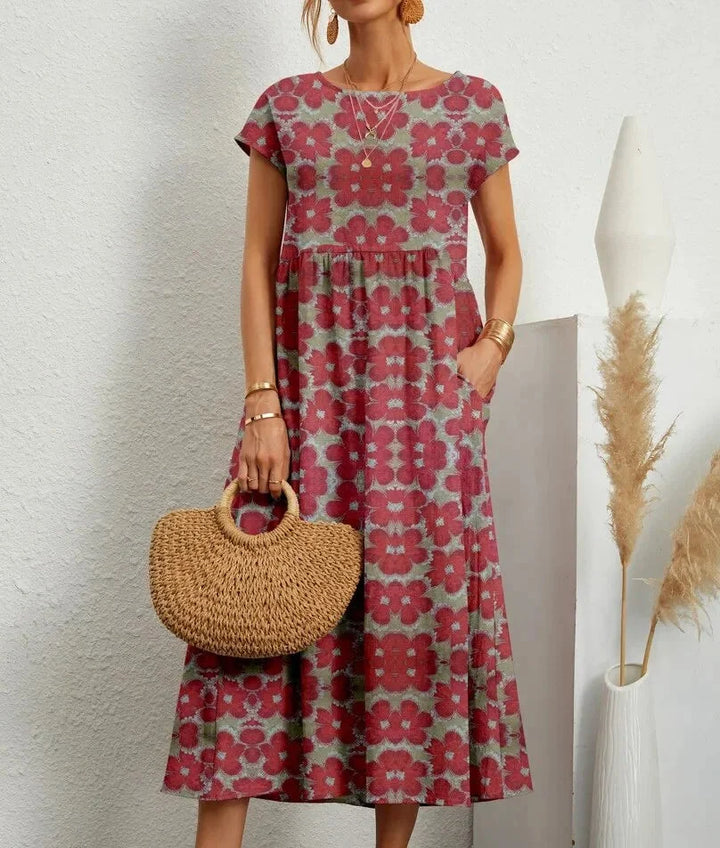 Red cotton midi dress featuring a delicate floral print. Perfect for a casual yet chic look.