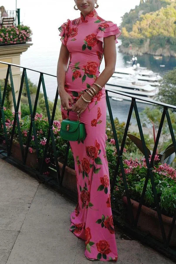 Pink floral-printed maxi dress with high neckline and ruffled sleeves. Soft, flowing fabric perfect for a spring or summer…