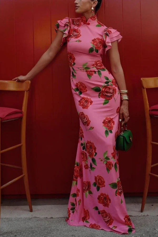 Pink floral maxi dress with high neckline, ruffled sleeves. Features a flowing design and delicate floral pattern in soft,…