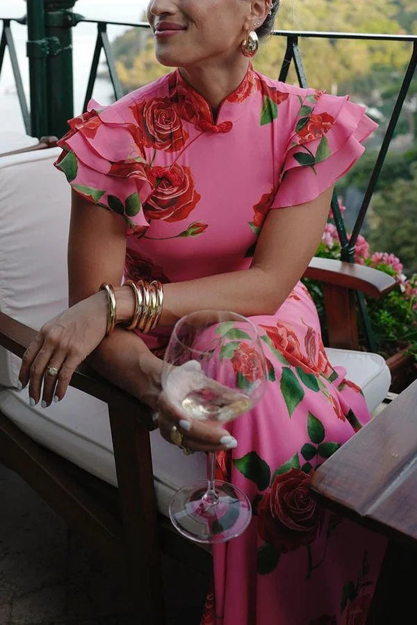 Pink floral maxi dress with high neckline and ruffled sleeves in soft, flowing fabric perfect for a graceful, feminine look.