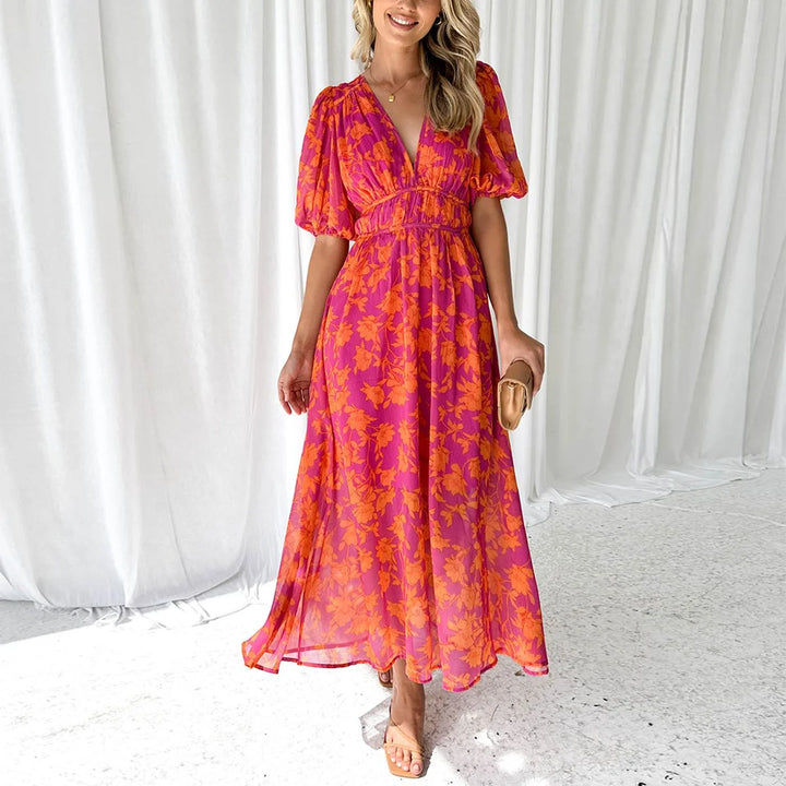 Bright pink floral maxi dress featuring a delicate willow pattern, ideal for a casual or formal wear with a flowy silhouette.