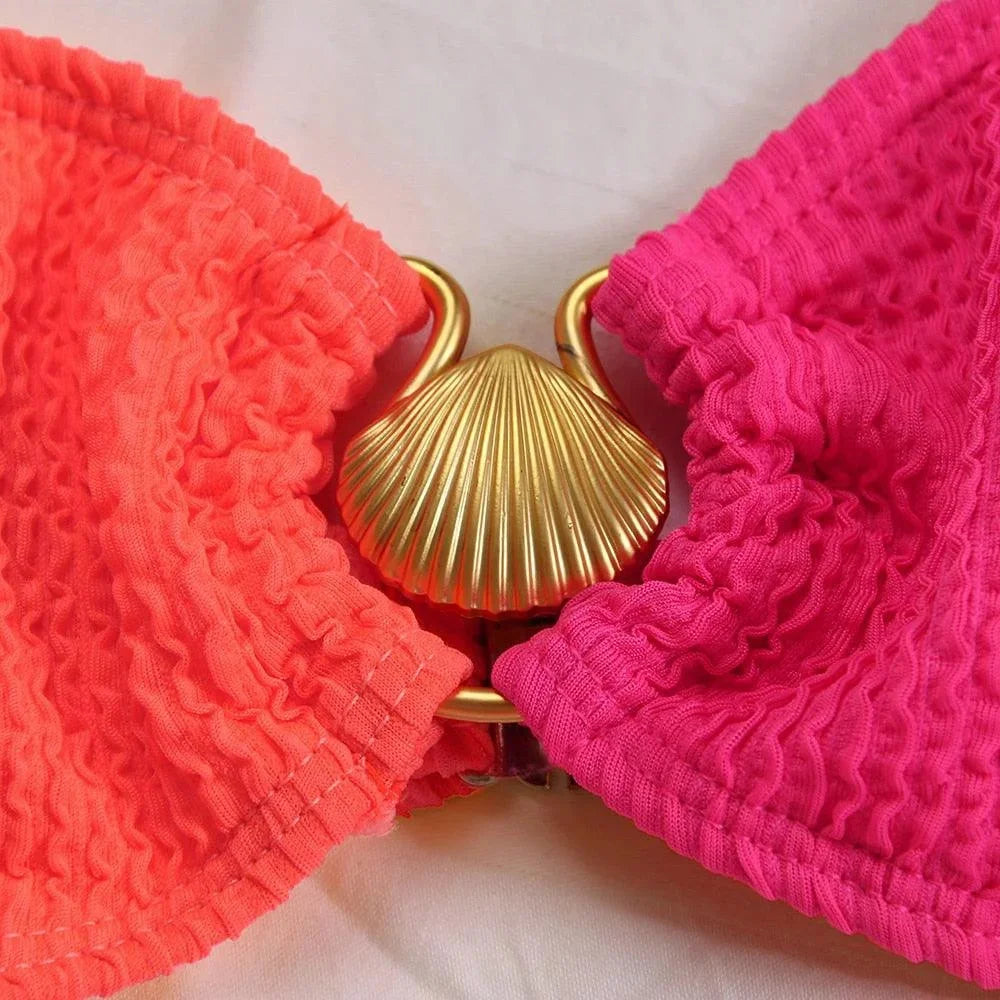 Women's asymmetrical bikini in textured fabric with unique design.