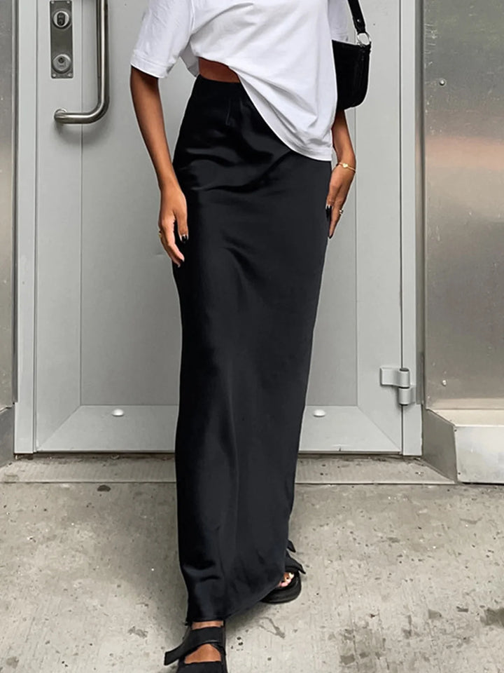 Flowy satin maxi skirt in elegant navy blue with a subtle sheen, perfect for effortless chic looks.