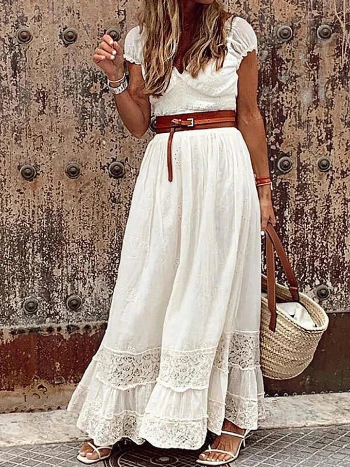 "Xavia V-neck belted lace maxi dress in navy blue with floral pattern and elbow sleeves, perfect for special occasions."