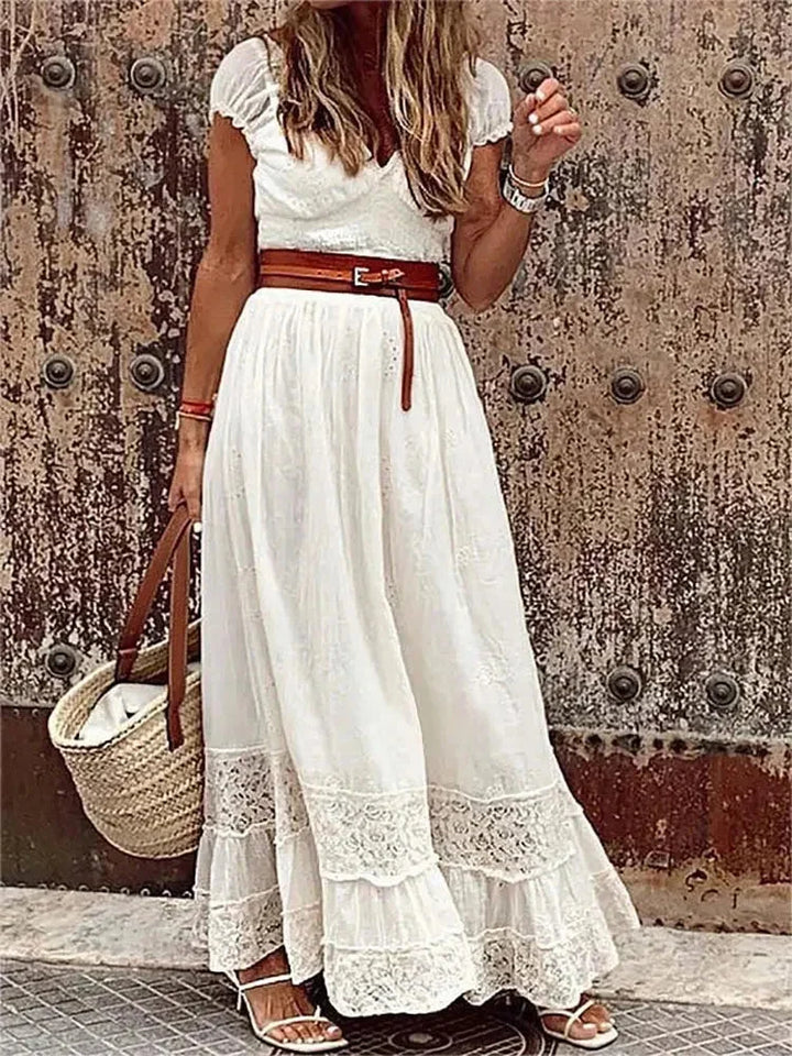 Black lace maxi dress with a V-neckline, belted waist, and elegant design.