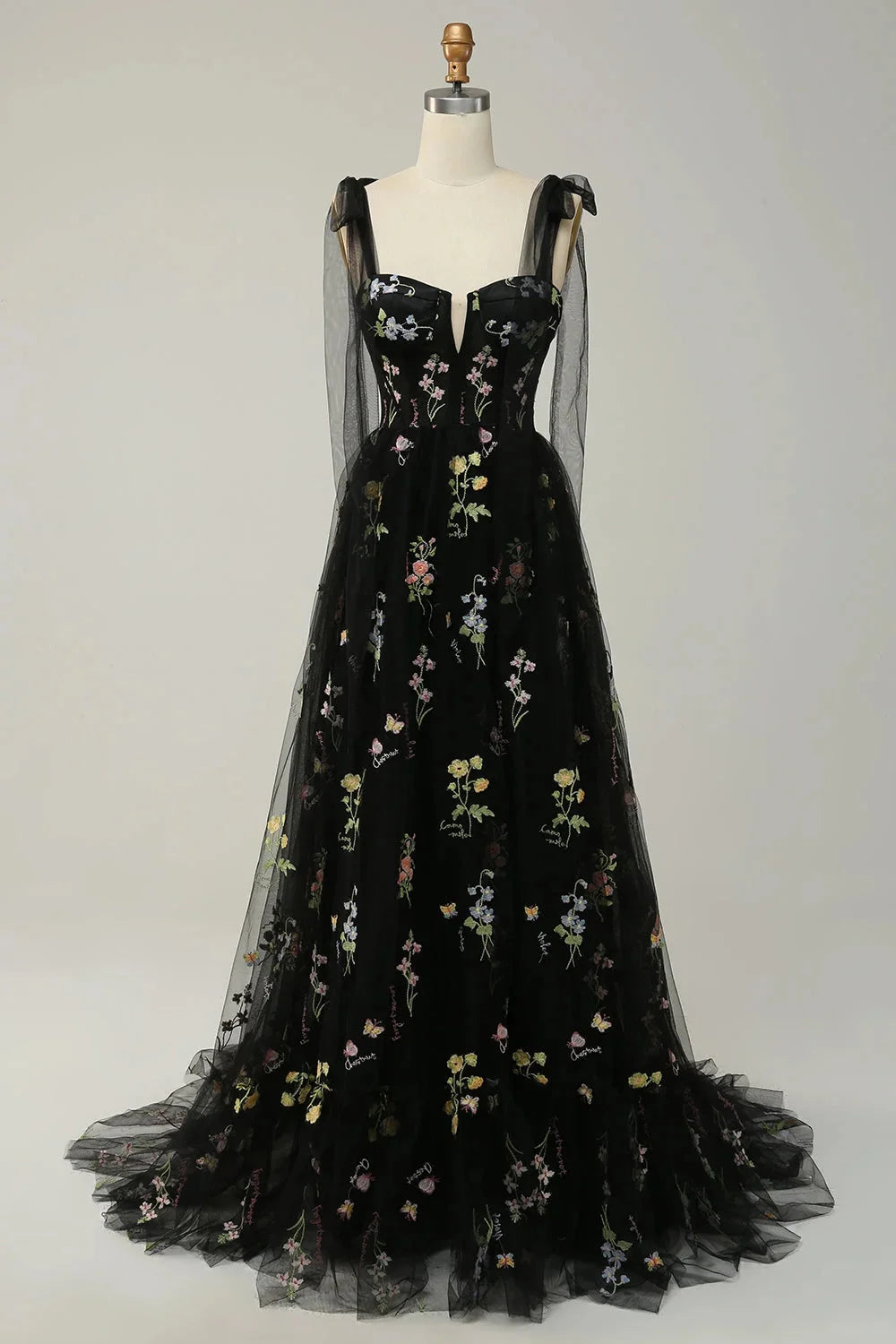 Pink tulle dress with delicate embroidery and sheer overlay by Yanely. Perfect for a special occasion or event.