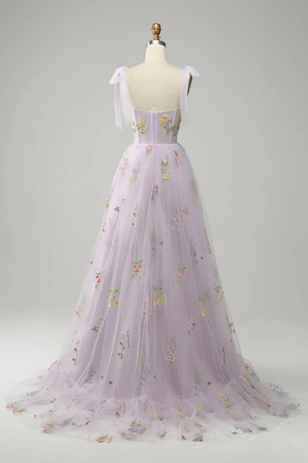 "Yanely tulle dress with sheer overlay, featuring elegant embroidery detail on a lightweight and flowy fabric."