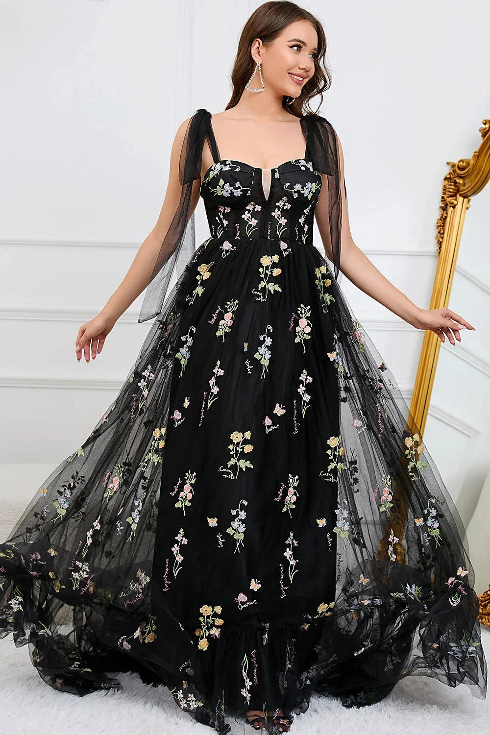 White tulle dress with intricate embroidery and sheer overlay, perfect for special occasions or formal events.