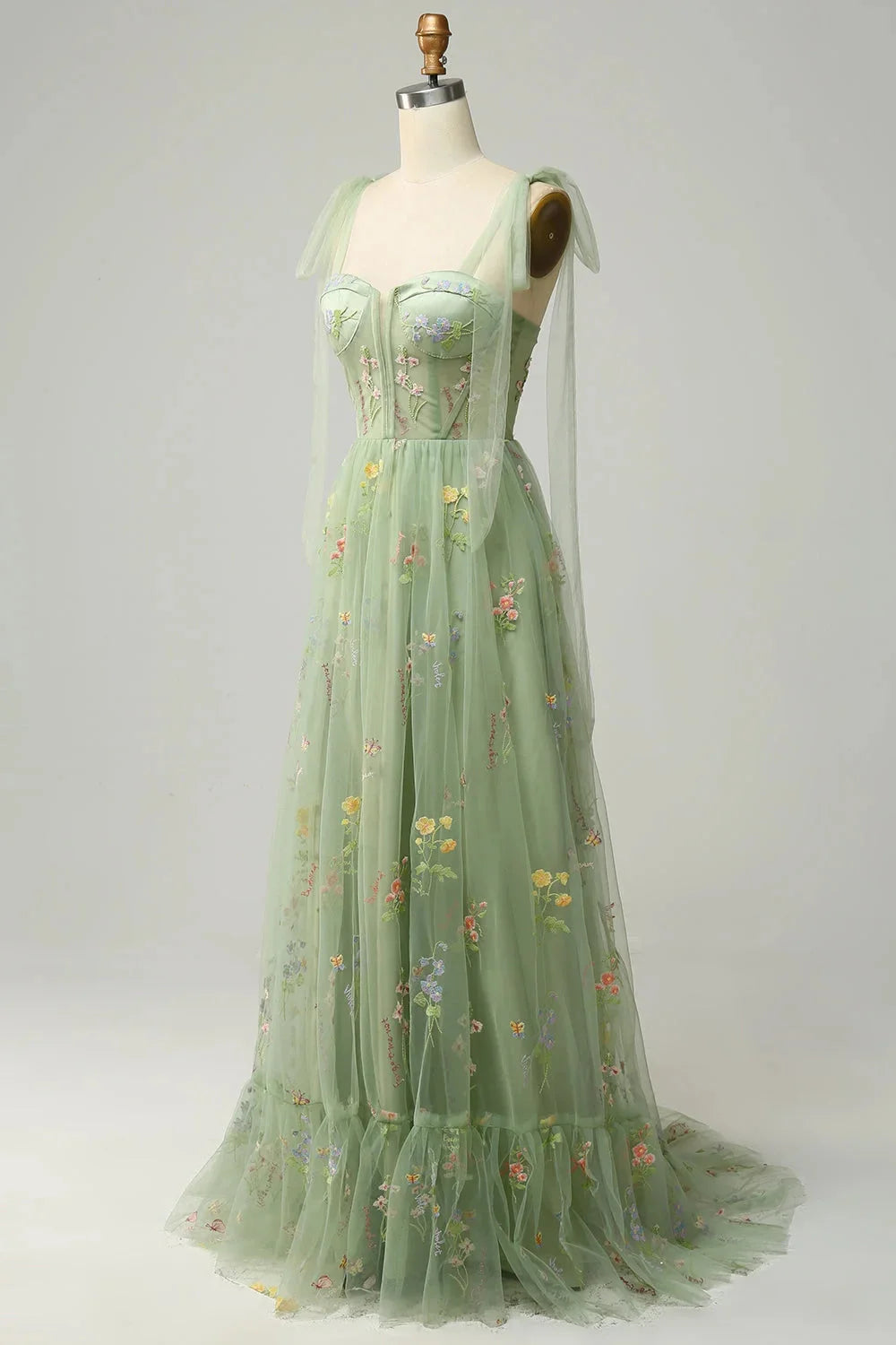 "Yanely embroidered tulle dress with sheer overlay, intricate floral embroidery on delicate sheer fabric."