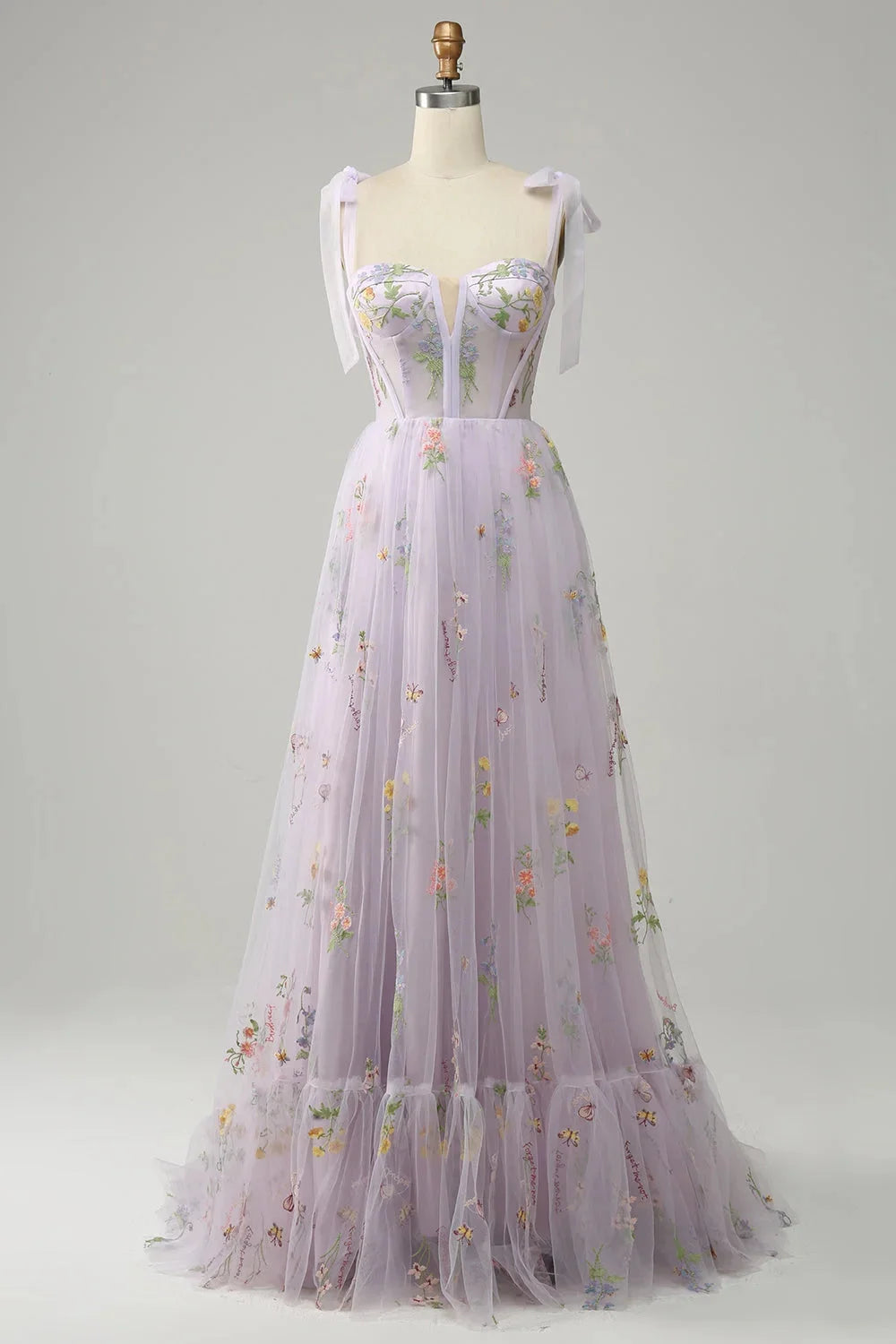 Lilac tulle dress with sheer overlay, adorned with intricate embroidery detailing.