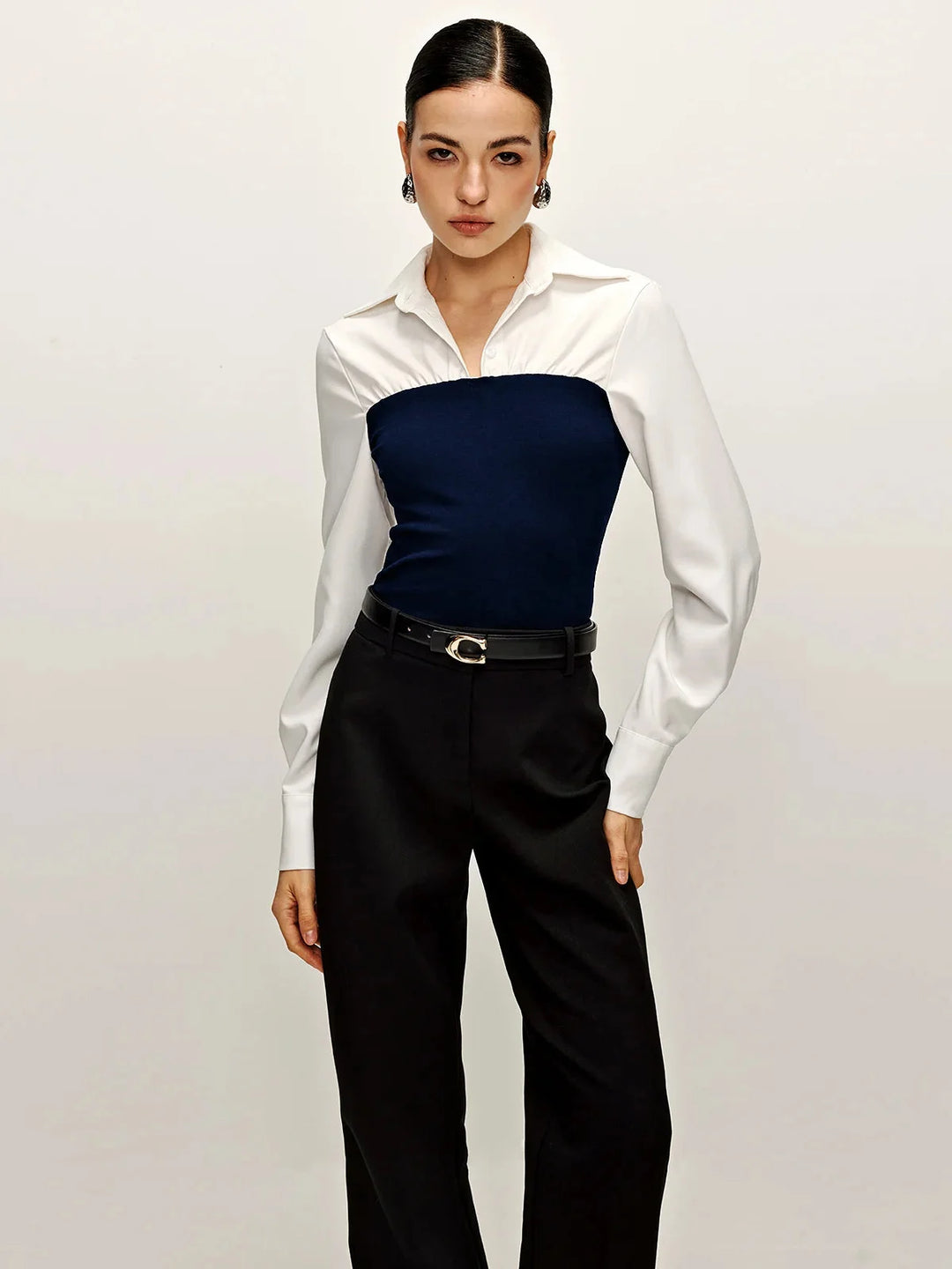 Blue two-tone tailored blouse with collar, made from soft and durable fabric. Features a sophisticated design perfect for…