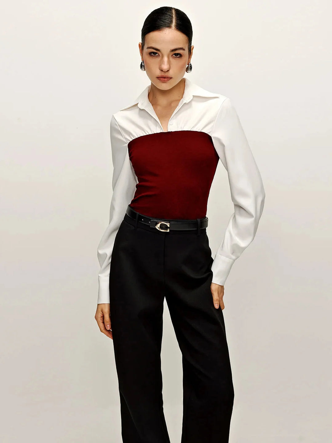 Red two-tone tailored blouse with collared neckline, timeless design in soft fabric perfect for formal occasions.