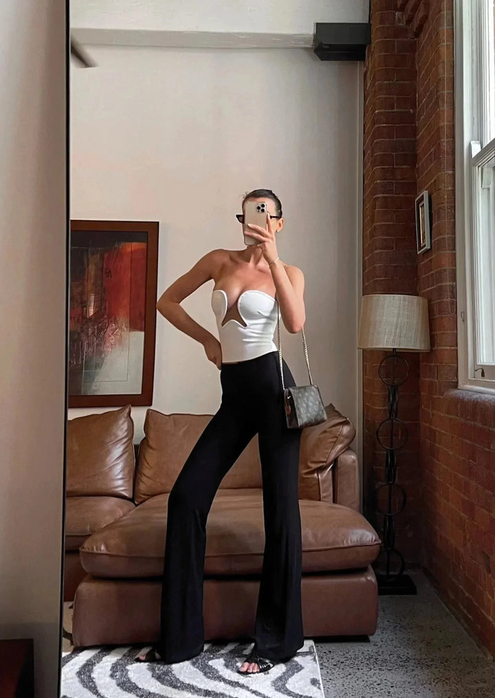 "Black strapless bustier with wavy trim for women, featuring a snug fit and sleek design"