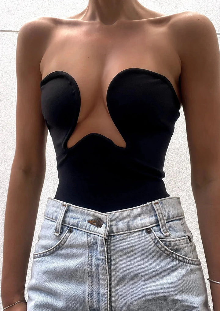 Women's black bustier with wavy trim and snug strapless design, perfect for a chic and stylish look.