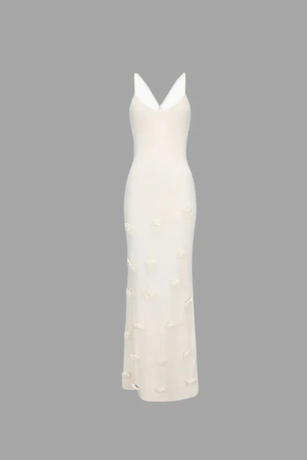 "White Zaia maxi dress with delicate floral appliqués, ideal for summer events, made from high-quality fabric"