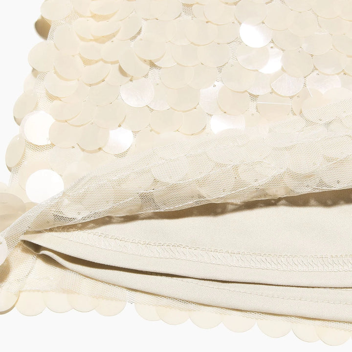 "Ivory sequin mini skirt with intricate detailing for a glamorous look."