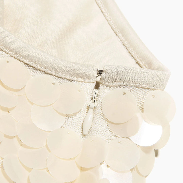 Ivory sequin mini skirt with sparkling design, perfect for adding a touch of glamour to your outfit.