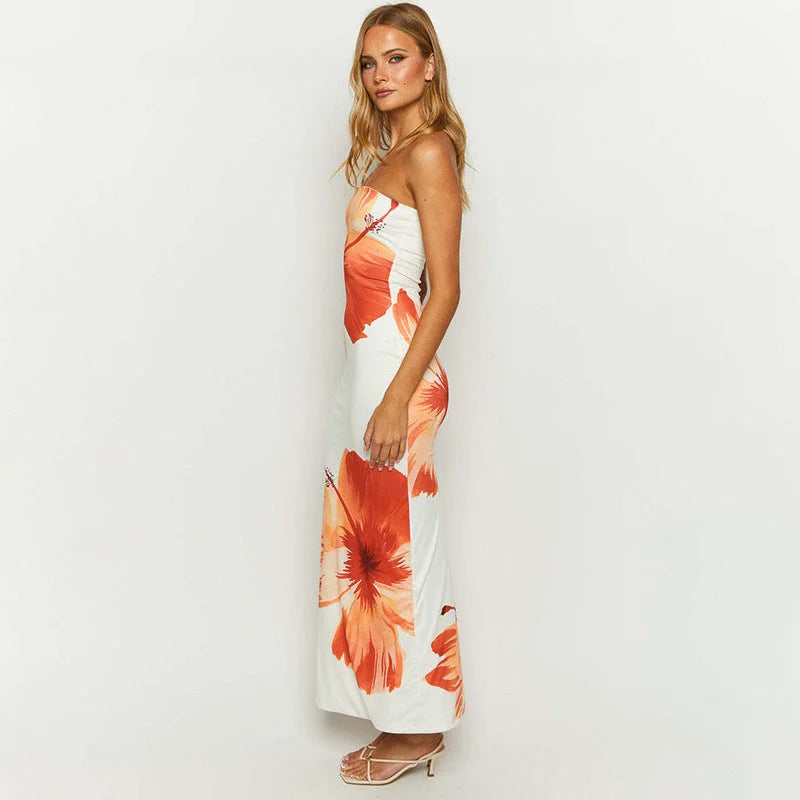 White and orange strapless floral maxi dress with a vibrant design perfect for summertime, made from lightweight and…