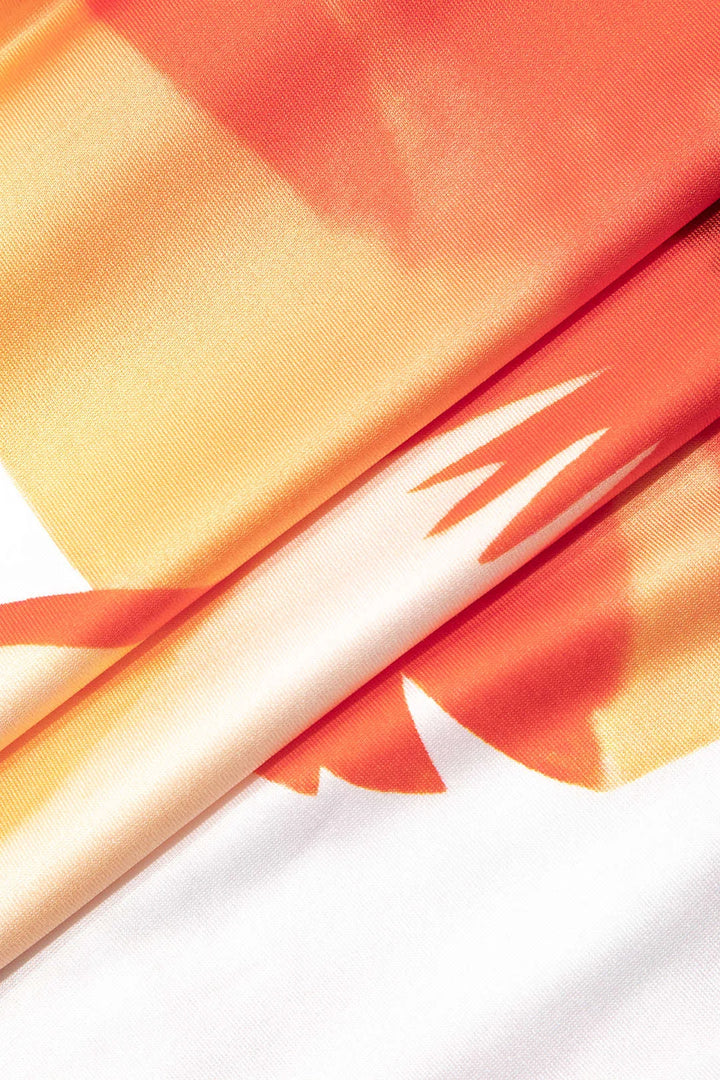 "Strapless floral maxi dress in white and orange with pleated design, ideal for sunny days and special occasions."