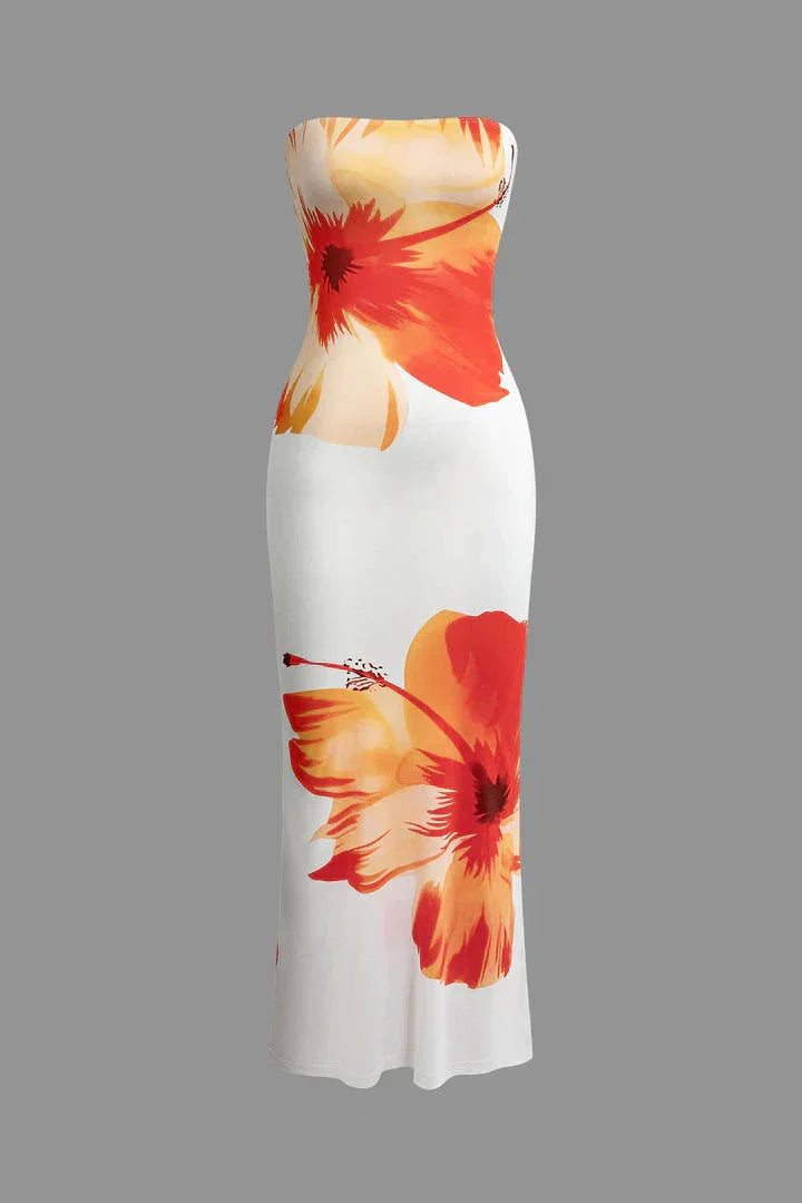 Strapless white and orange maxi dress with floral pattern, ideal for summer occasions, made from lightweight fabric.