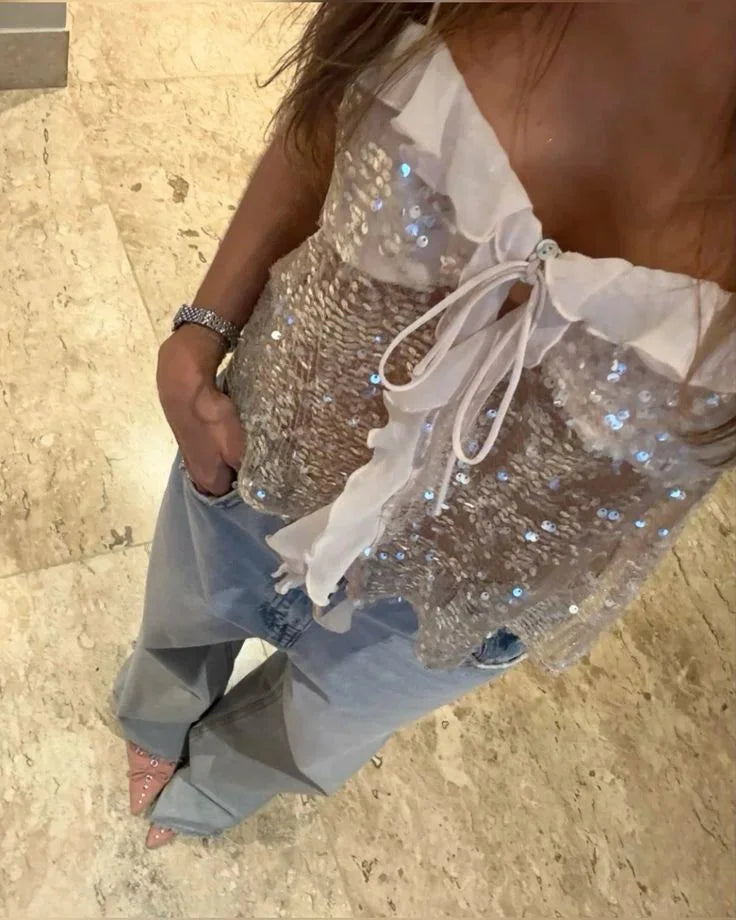 "Women's sequin top with sheer ruffle detail, perfect for a chic and glamorous look."