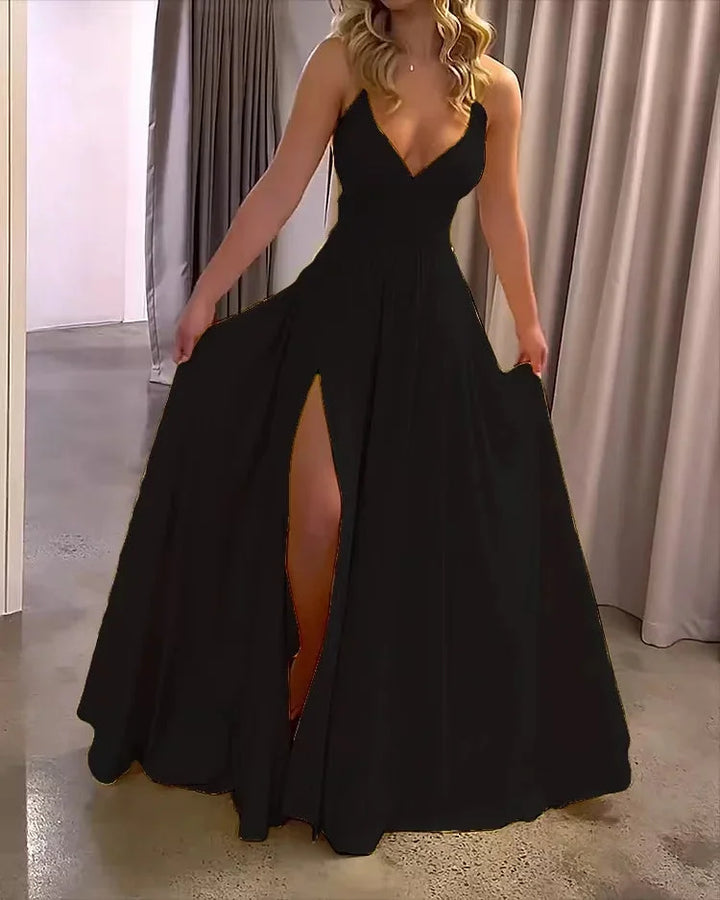 Black Zeppelin maxi dress with deep slit, made from flowing fabric. Features elegant design perfect for any occasion.