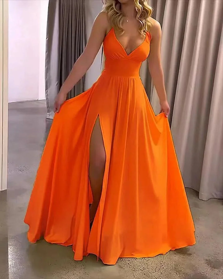 Orange flowing maxi dress with a deep slit, perfect for a summer day out, made from soft and breezy fabric.