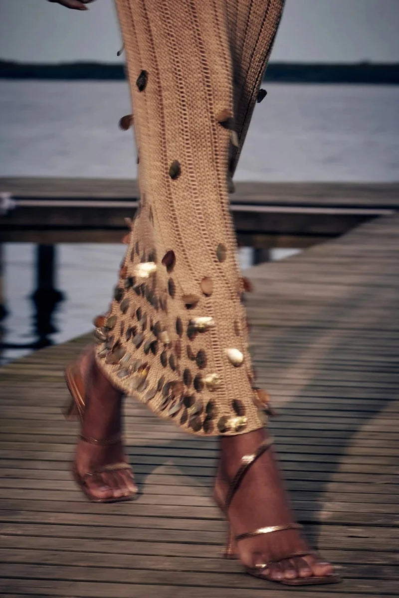 Sheer gold dress with sequin details, spaghetti straps, and V-neck, perfect for special occasions.