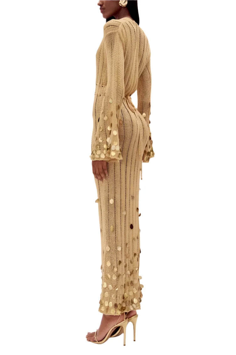 Sheer gold dress with sparkling sequin details, perfect for a glamorous night out.