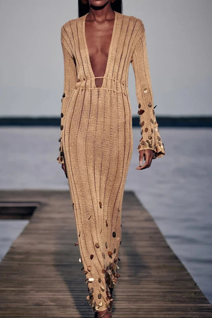 Gold sheer dress with sequin accents. Perfect for evening events or special occasions. Elegant and sophisticated design.