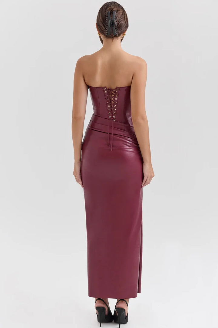 Black strapless fitted maxi dress with flattering ruched detailing along the bodice and a flowy skirt, made from a soft and…