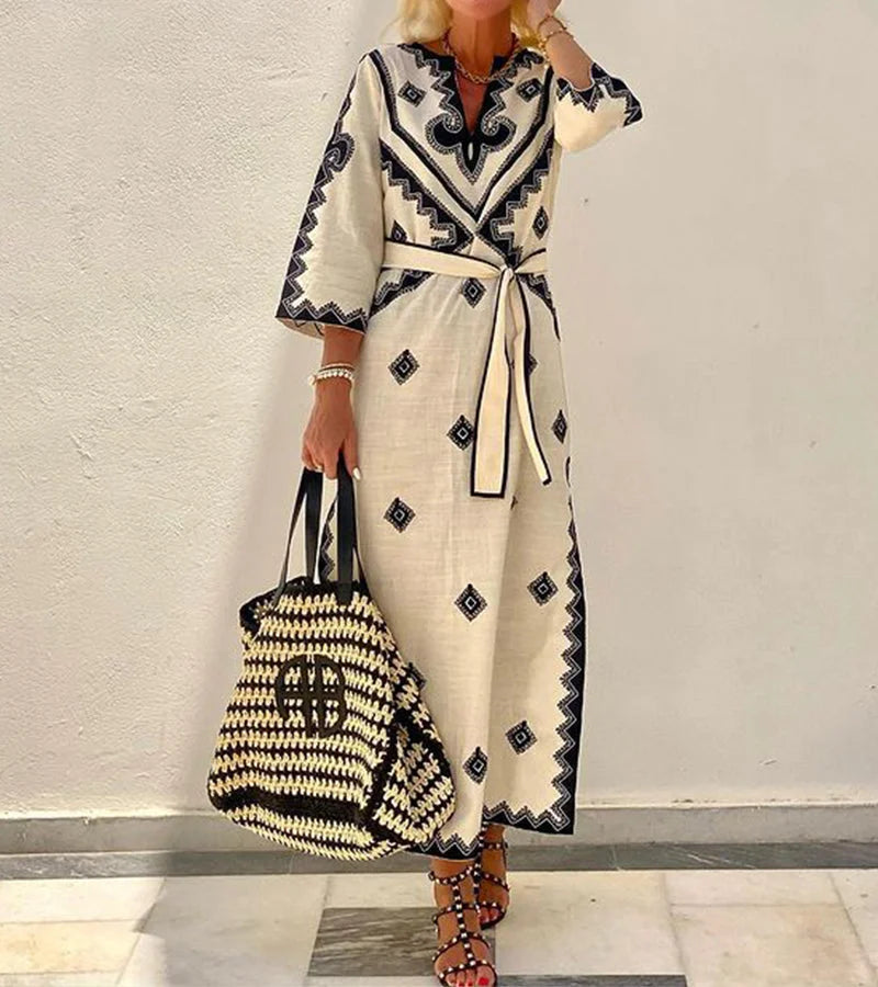 "Beige printed maxi kaftan with belt, featuring intricate pattern design on lightweight fabric. Perfect for effortless…